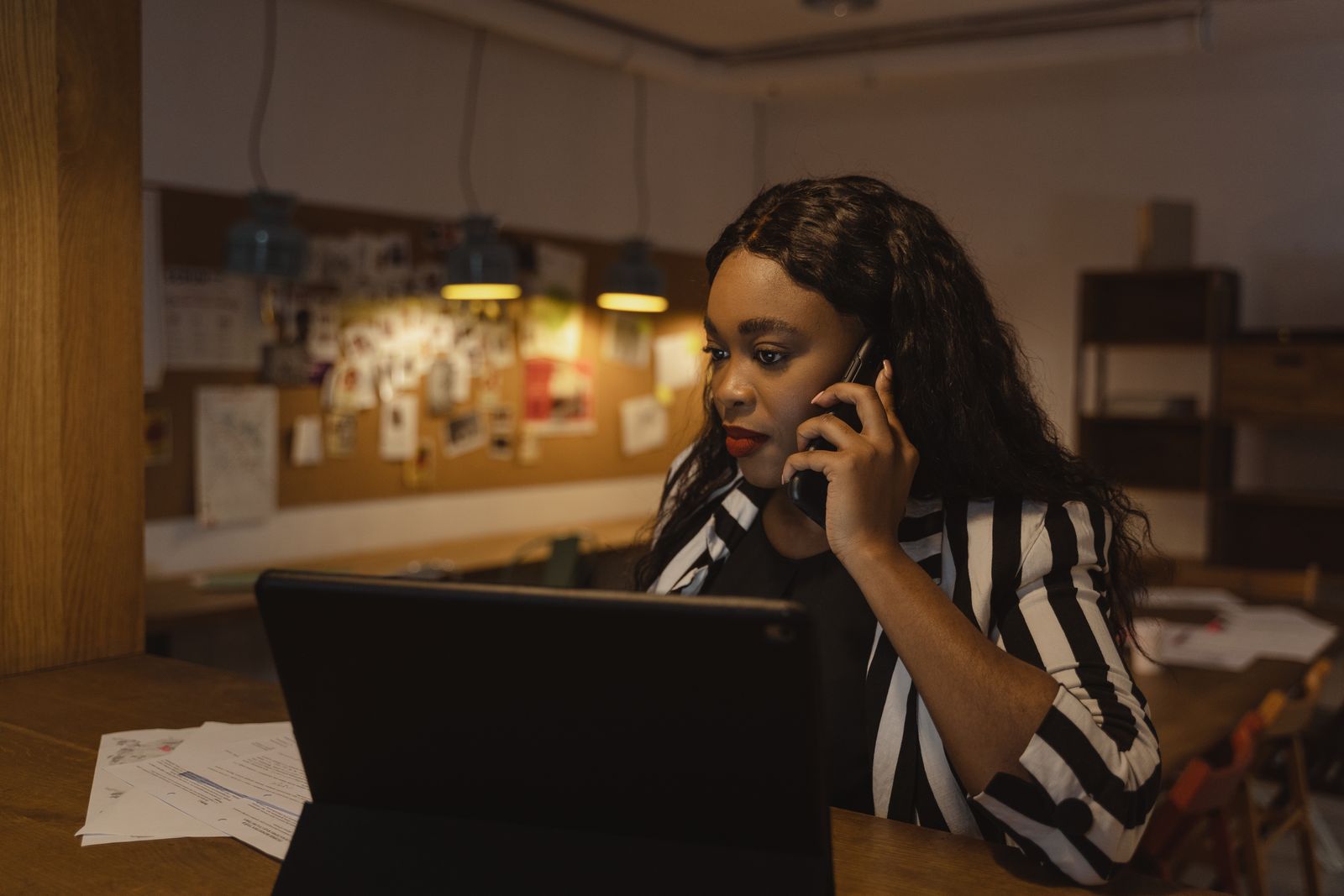 A Book with Hadey travel consultant at her desk, taking a customer's call about booking a flight